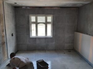 Håndværker lægger fliser i nyt badeværelse